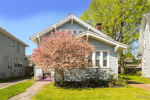 82 Radcliffe Rd, Buffalo, NY 14214 - view of front of property featuring a front lawn and a chimney