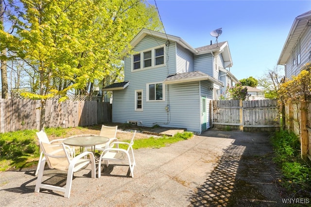 82 Radcliffe Rd, Buffalo, NY 14214 - back of property with a patio area, a fenced backyard, roof with shingles, and outdoor dining area