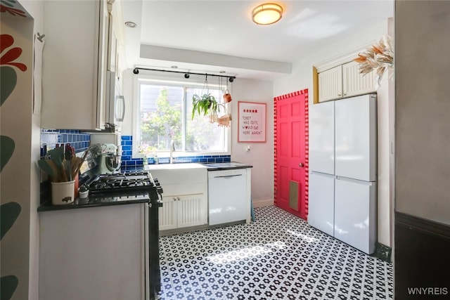 82 Radcliffe Rd, Buffalo, NY 14214 - kitchen featuring white appliances, dark countertops, and a sink