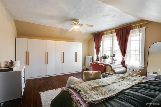 82 Radcliffe Rd, Buffalo, NY 14214 - bedroom with vaulted ceiling, radiator, dark wood finished floors, ceiling fan, and a textured ceiling