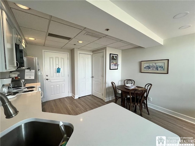 1 Pratt Ave Unit 407, Chautauqua, NY 14722 - kitchen with light countertops, dark wood-type flooring, baseboards, a sink, and a drop ceiling