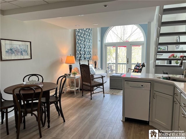 1 Pratt Ave Unit 407, Chautauqua, NY 14722 - kitchen featuring a sink, dishwasher, wood finished floors, light countertops, and gray cabinetry