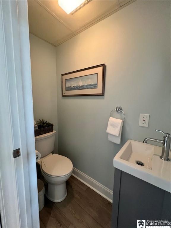 1 Pratt Ave Unit 407, Chautauqua, NY 14722 - bathroom featuring wood finished floors, toilet, baseboards, and vanity
