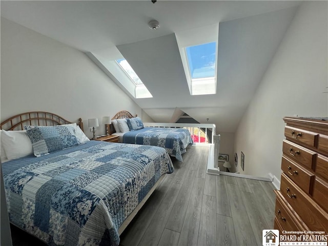 1 Pratt Ave Unit 407, Chautauqua, NY 14722 - bedroom featuring a skylight, vaulted ceiling, wood finished floors, and baseboards