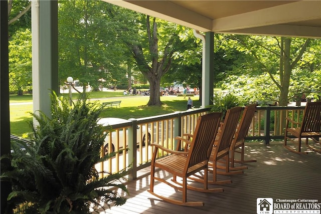 1 Pratt Ave Unit 407, Chautauqua, NY 14722 - wooden deck with a porch and a lawn