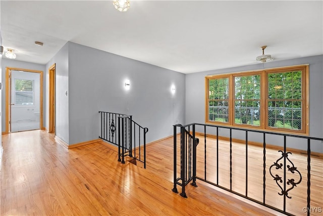 7565 Audrey Dr, Clay, NY 13212 - hall featuring an upstairs landing, wood finished floors, and baseboards