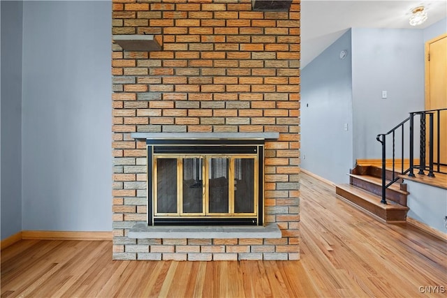 7565 Audrey Dr, Clay, NY 13212 - detailed view of wood finished floors, baseboards, and a multi sided fireplace