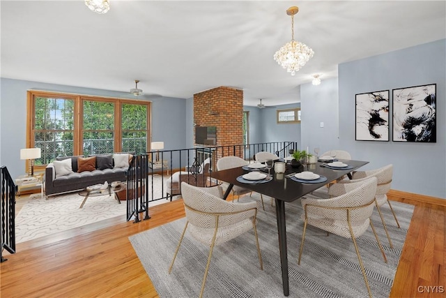 7565 Audrey Dr, Clay, NY 13212 - dining space featuring light wood-type flooring, a chandelier, and baseboards
