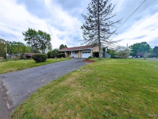 7565 Audrey Dr, Clay, NY 13212 - ranch-style house featuring asphalt driveway, an attached garage, and a front lawn