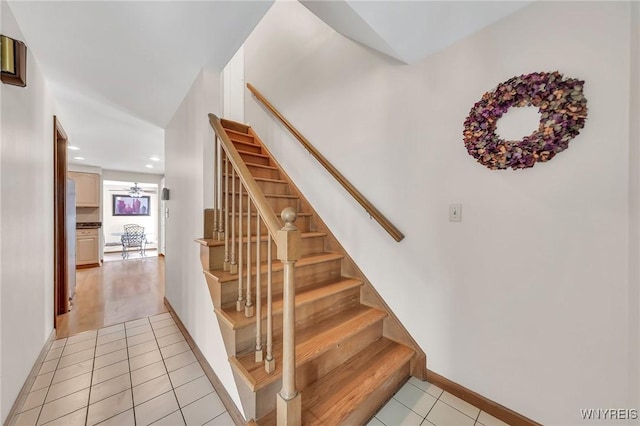 stairs featuring tile patterned flooring, recessed lighting, and baseboards