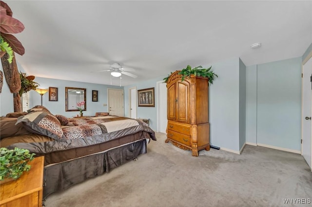 carpeted bedroom featuring baseboards and a ceiling fan