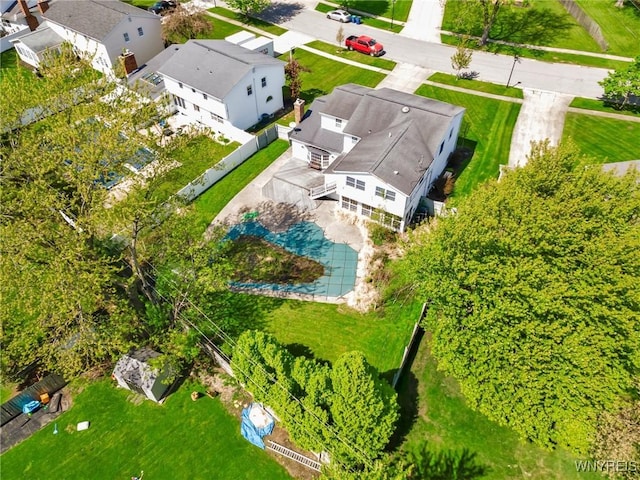 aerial perspective of suburban area featuring a pool area