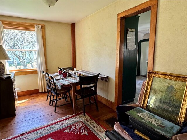 2395 State Highway 205, Laurens, NY 13810 - dining space featuring a textured wall, hardwood / wood-style flooring, and baseboards