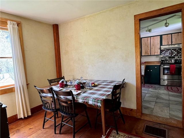 2395 State Highway 205, Laurens, NY 13810 - dining space with wood finished floors, a textured wall, and baseboards