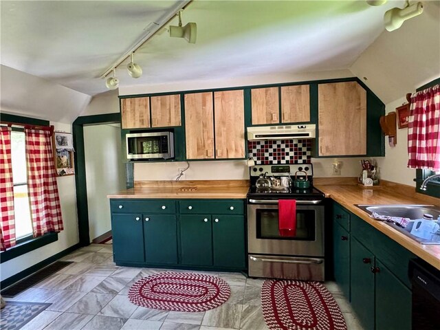 2395 State Highway 205, Laurens, NY 13810 - kitchen with appliances with stainless steel finishes, under cabinet range hood, a sink, vaulted ceiling, and rail lighting
