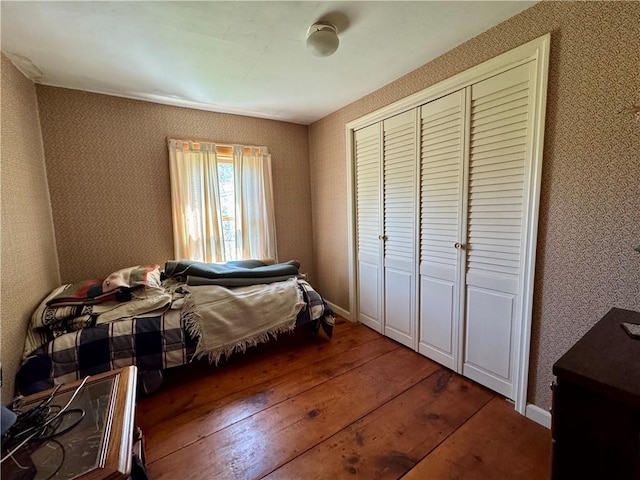 2395 State Highway 205, Laurens, NY 13810 - bedroom with wood-type flooring, a closet, and baseboards