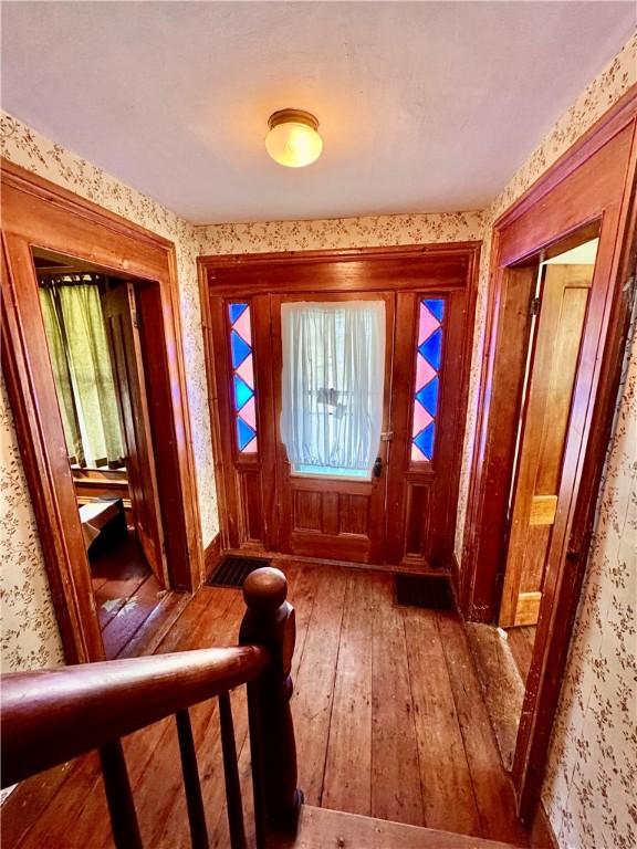 2395 State Highway 205, Laurens, NY 13810 - foyer featuring wallpapered walls, hardwood / wood-style floors, and healthy amount of natural light