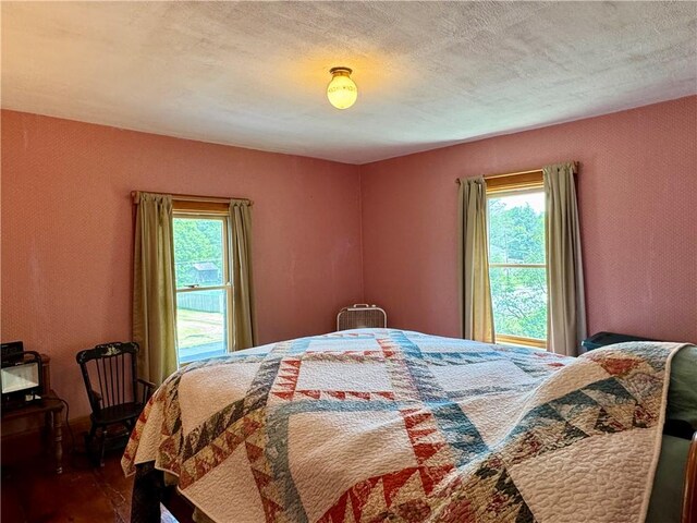 2395 State Highway 205, Laurens, NY 13810 - bedroom featuring dark wood finished floors and a textured ceiling