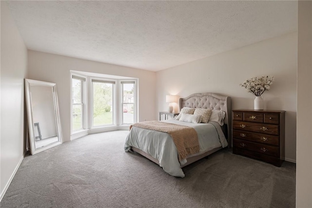 carpeted bedroom with a textured ceiling and baseboards
