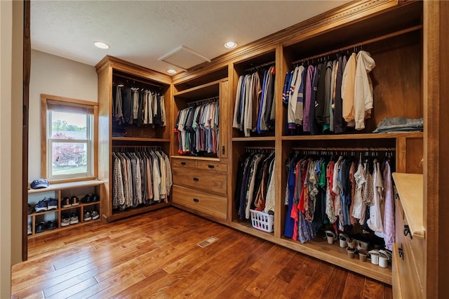 spacious closet featuring wood-type flooring and attic access