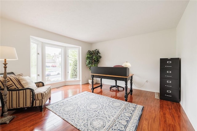 office featuring wood finished floors and baseboards
