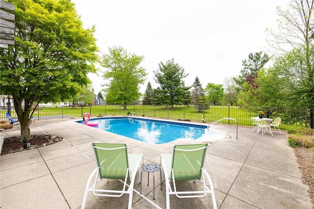 view of pool with a patio and fence