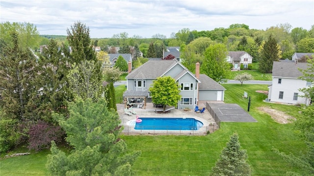 view of swimming pool with a lawn, a patio area, and a residential view