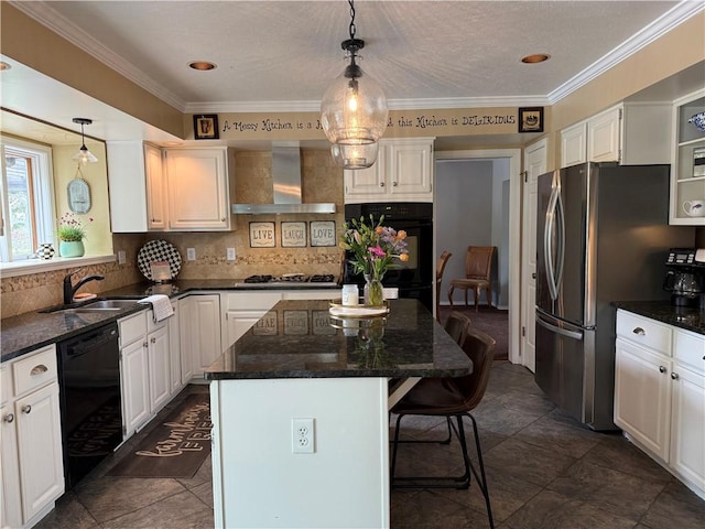 kitchen with black appliances, wall chimney range hood, a sink, a breakfast bar, and decorative backsplash