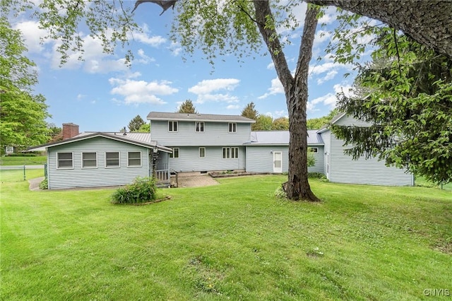 back of house featuring a lawn