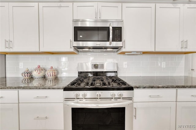 6811 Rivera Way, Clarence, NY 14051 - kitchen featuring appliances with stainless steel finishes, white cabinetry, dark stone counters, and backsplash