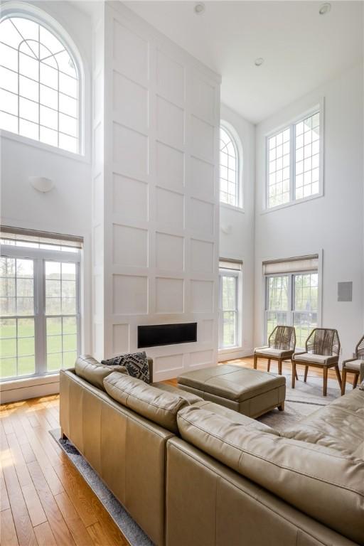 313 Wexford Ln, Horseheads, NY 14845 - living room featuring a towering ceiling, light wood-style floors, and a fireplace