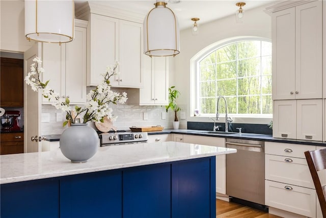 313 Wexford Ln, Horseheads, NY 14845 - kitchen featuring appliances with stainless steel finishes, a sink, backsplash, light stone countertops, and white cabinetry