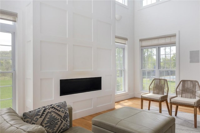 313 Wexford Ln, Horseheads, NY 14845 - living area featuring a fireplace, light wood-style floors, and a towering ceiling