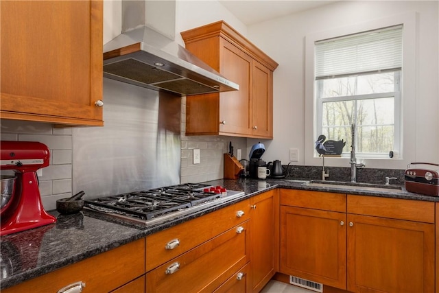 313 Wexford Ln, Horseheads, NY 14845 - kitchen with wall chimney exhaust hood, a sink, brown cabinets, dark stone countertops, and decorative backsplash