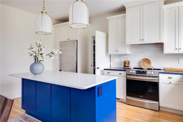 313 Wexford Ln, Horseheads, NY 14845 - kitchen featuring appliances with stainless steel finishes, decorative backsplash, light wood finished floors, a kitchen island, and white cabinetry