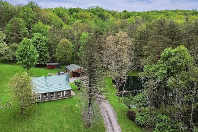 view of subject property with a heavily wooded area