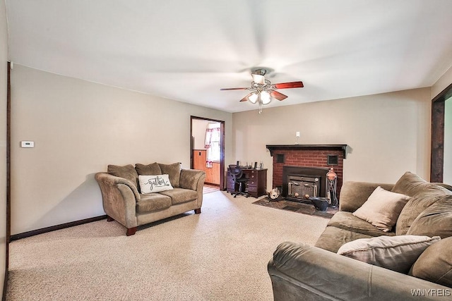 carpeted living room with a ceiling fan, baseboards, and a brick fireplace