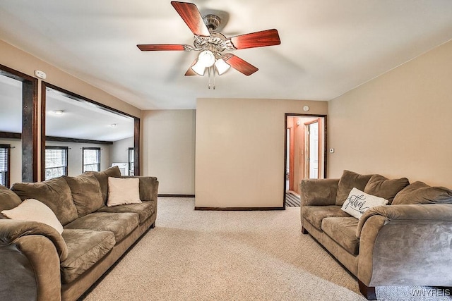 living room with light carpet, ceiling fan, and baseboards
