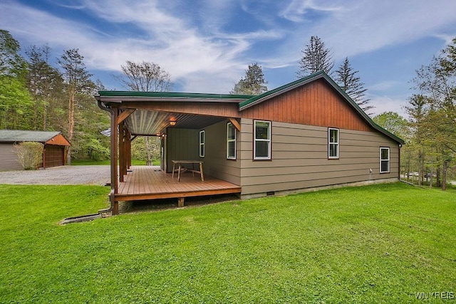 back of property with crawl space, a yard, an outdoor structure, and a deck