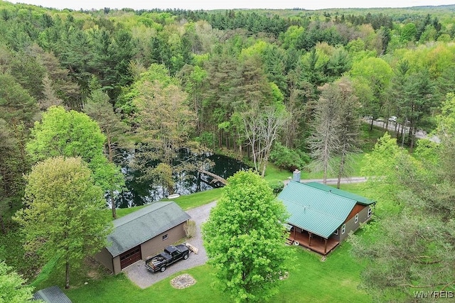 aerial view of property and surrounding area featuring a forest