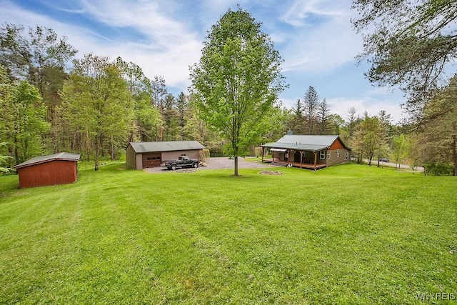view of green lawn with an outbuilding