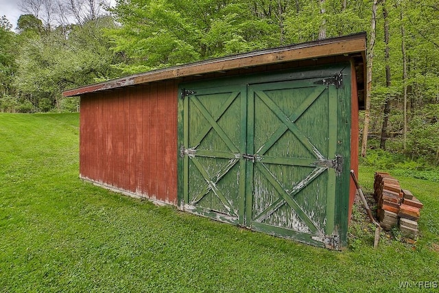view of shed with a forest view