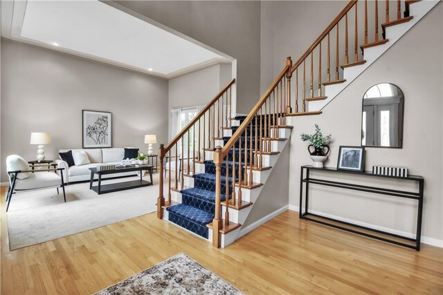 670 Raymond Dr, Lewiston, NY 14092 - stairway with wood finished floors, baseboards, plenty of natural light, recessed lighting, and a towering ceiling