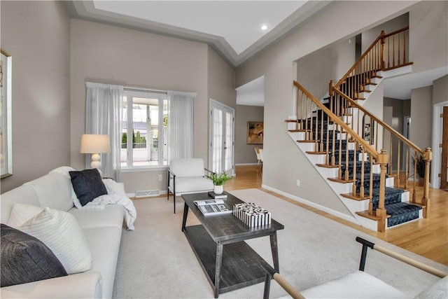 670 Raymond Dr, Lewiston, NY 14092 - living area featuring a towering ceiling, baseboards, stairway, wood finished floors, and recessed lighting
