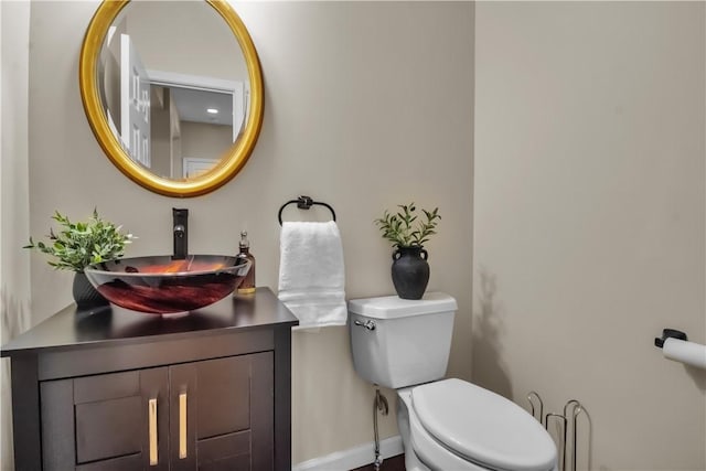 670 Raymond Dr, Lewiston, NY 14092 - bathroom featuring toilet, vanity, and baseboards