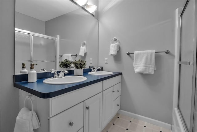 670 Raymond Dr, Lewiston, NY 14092 - full bathroom with a shower with shower door, double vanity, and baseboards