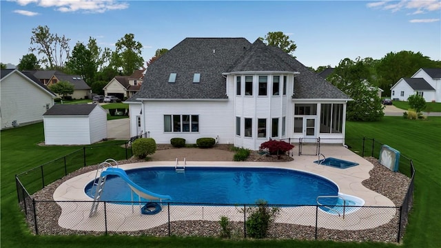 670 Raymond Dr, Lewiston, NY 14092 - rear view of house with a sunroom, a shingled roof, an outdoor structure, and a patio area