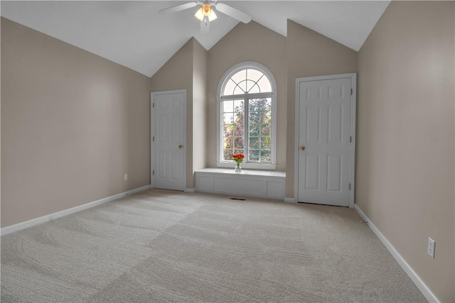 670 Raymond Dr, Lewiston, NY 14092 - spare room with ceiling fan, light carpet, baseboards, and high vaulted ceiling