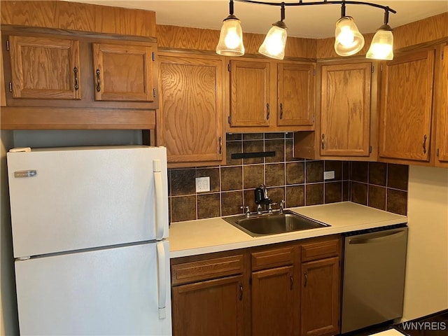 5854 Main St Unit 407, Amherst, NY 14221 - kitchen featuring freestanding refrigerator, stainless steel dishwasher, a sink, light countertops, and tasteful backsplash
