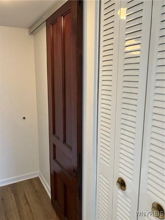5854 Main St Unit 407, Amherst, NY 14221 - hallway featuring dark wood-style floors and baseboards